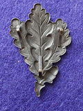 Original WW2 German Jager oakleaf insignia alloy cap badge